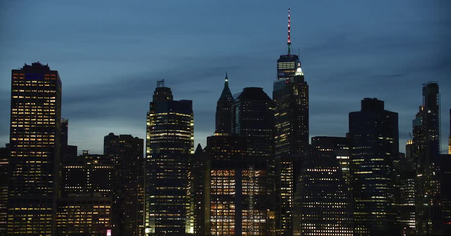 Aerial view of a downtown city is displayed at night