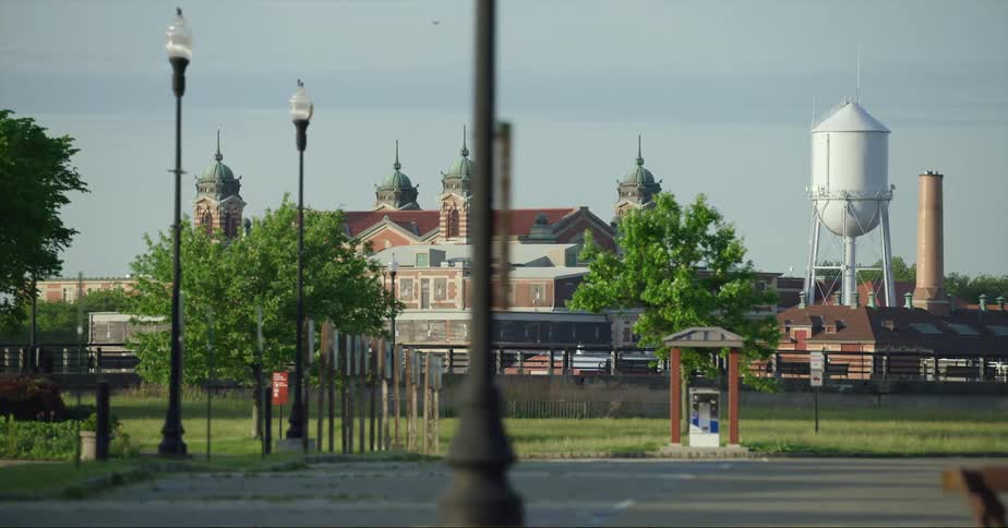 A building with four towers and spires on top is near a water tower