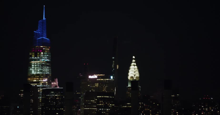 Colorful city lightsform display on tops of skyscrapers at night