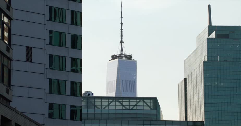 Exterior view of skyscraper with spire and office buildings in the city