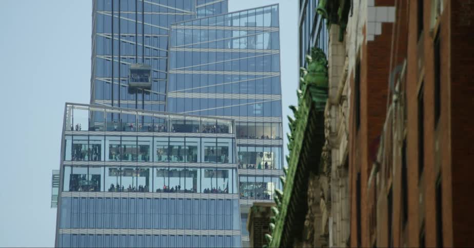 A tall glass skyscraper in a city on a clear day