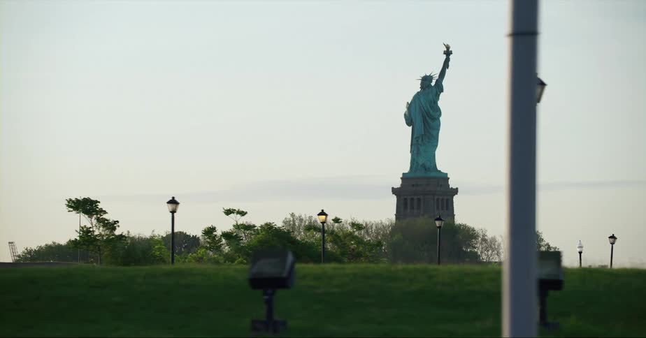 The statue of liberty is shown at a park in spring