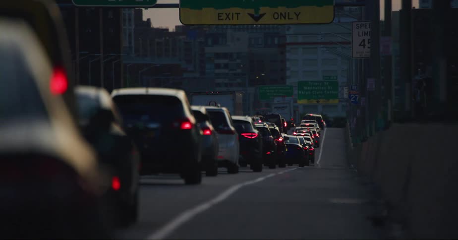 Cars driving on the heavy traffic on a highway in the city at evening