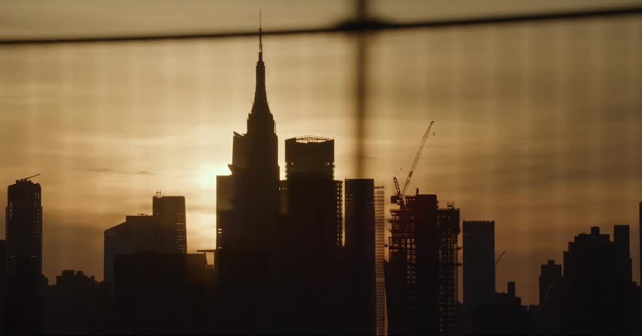 Aerial view of the sun setting in an urban city