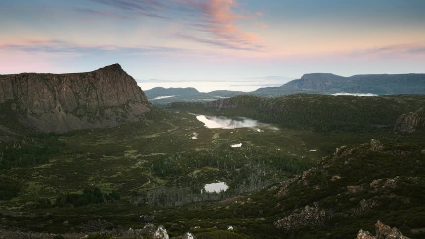 A time lapse of a mountainous landscape shows clouds passing by