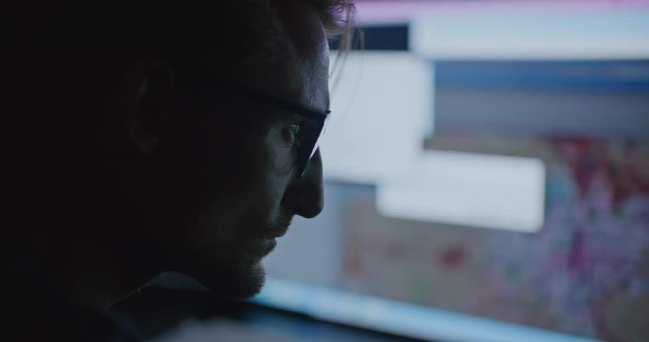 A man in an office looks at computers