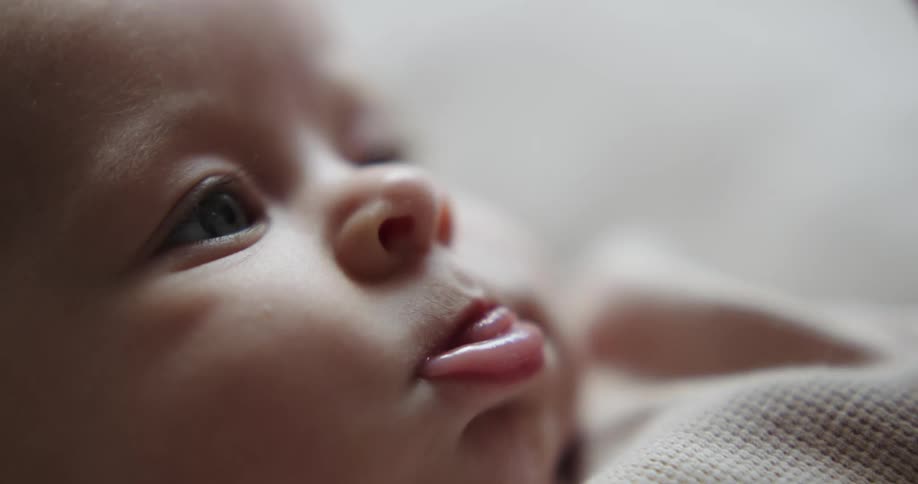 Close up of a baby sticking its tongue out