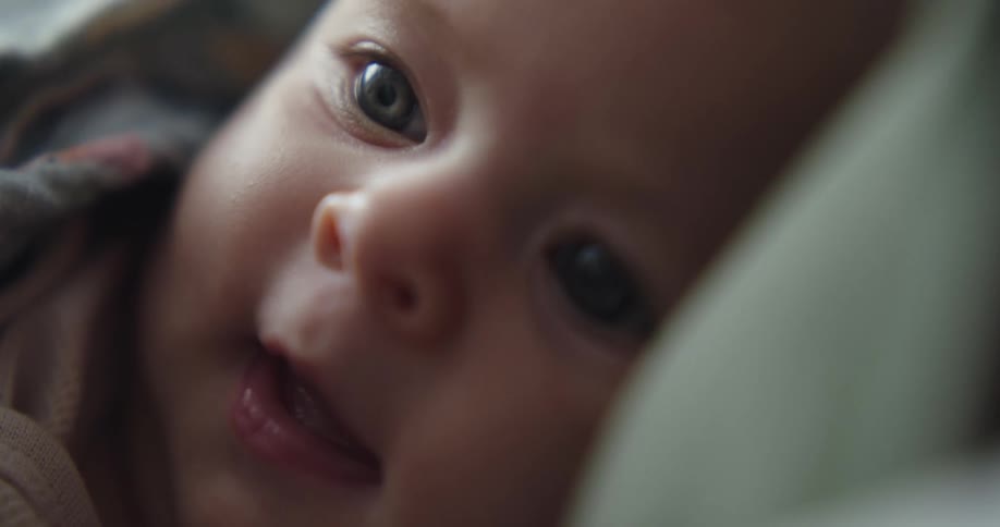 Close up of babys face looking into space