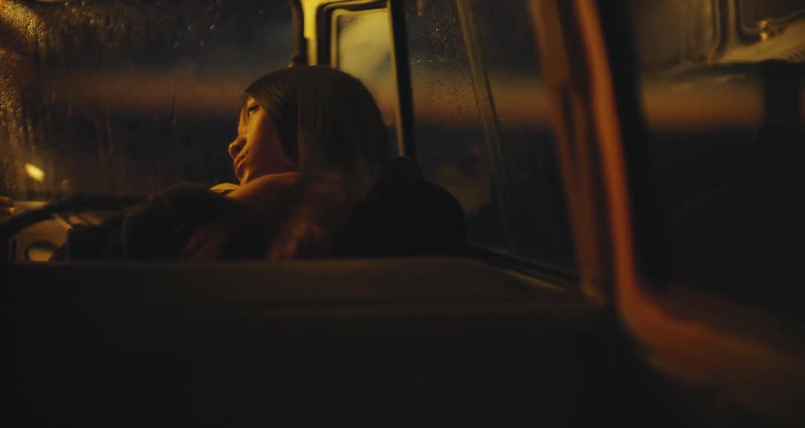 A woman sits backward in a seat in a classic VW van