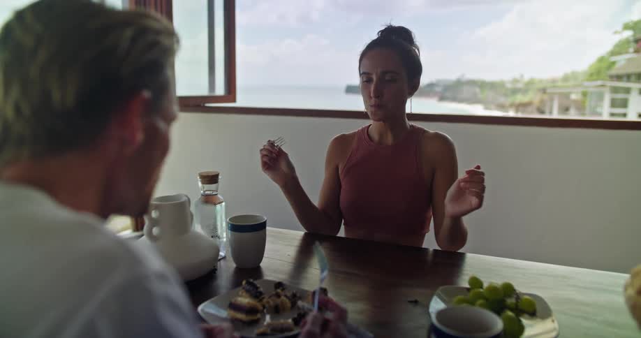Couple eating seafood on a tropical beachfront apartment at daytime