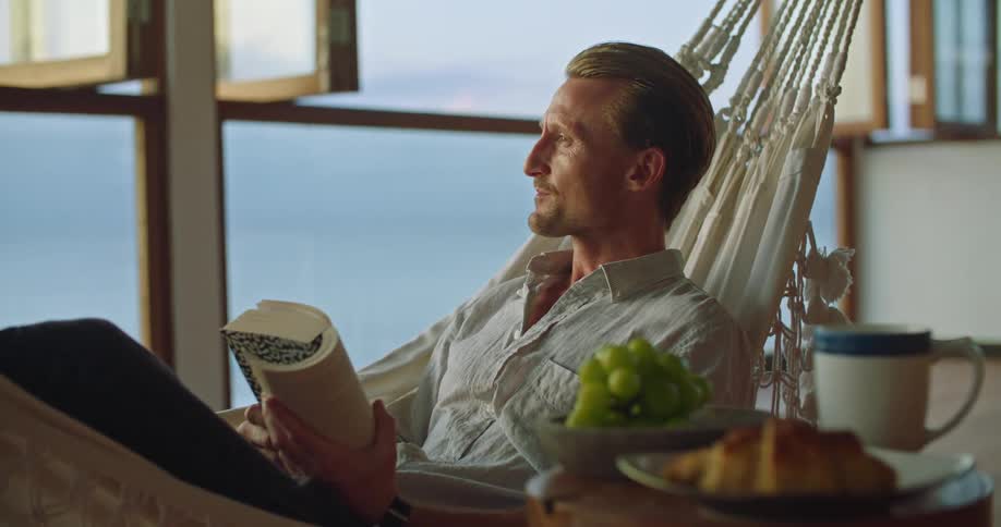A man is resting in a hammock
