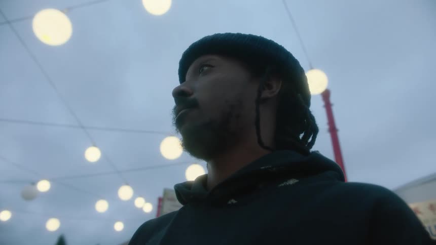 A man is standing outdoors in a city