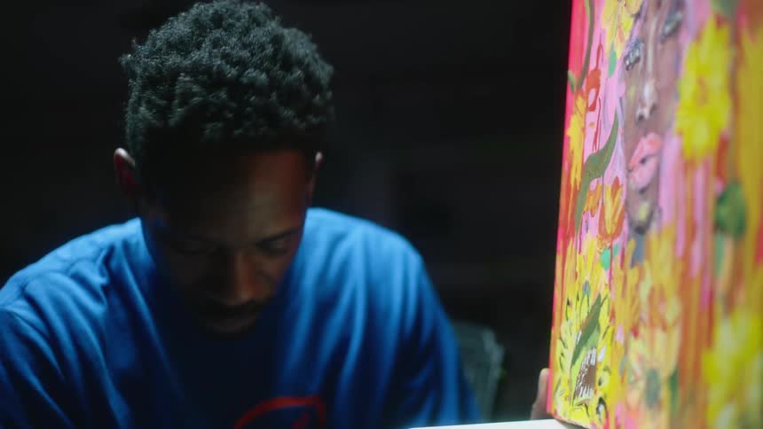 A man painting on a canvas