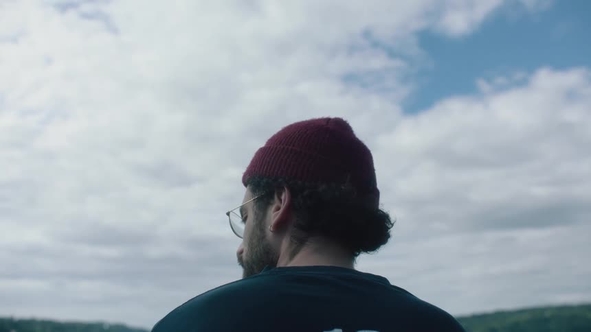 A man standing outdoors looking into the distance