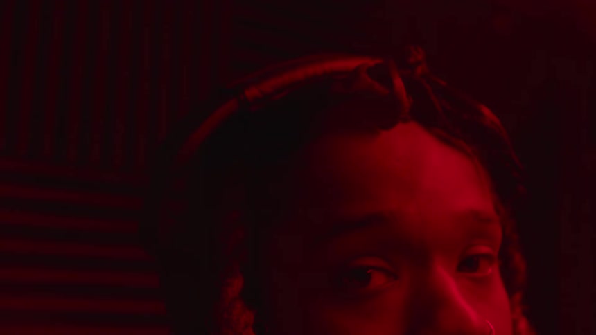 Close up of the hairstyle of a young girl on a room under red lights
