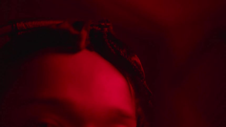 Close up of the hairstyle of a young girl on a room under red lights