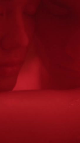 Close up of a man and womans face as they hug