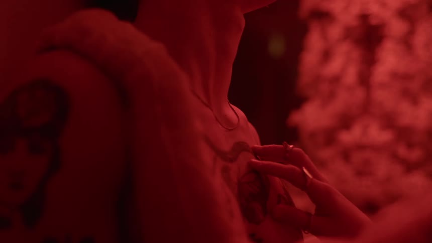 A woman caresses a mans bare chest