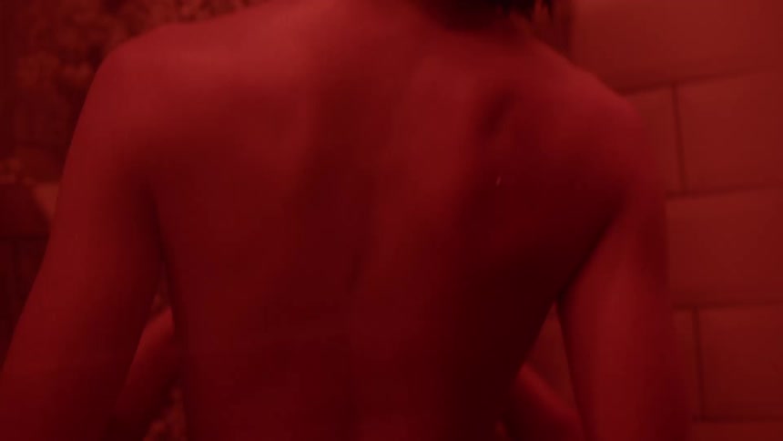 A woman is standing in the shower