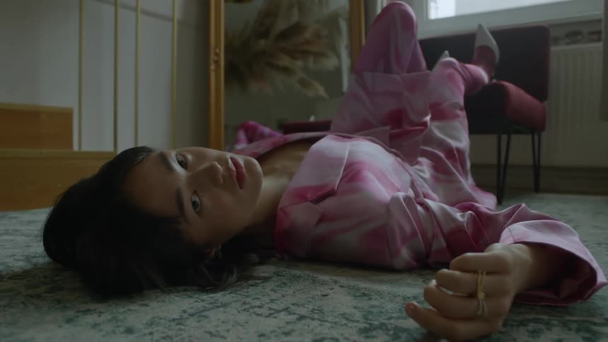 A woman is alying on the floor