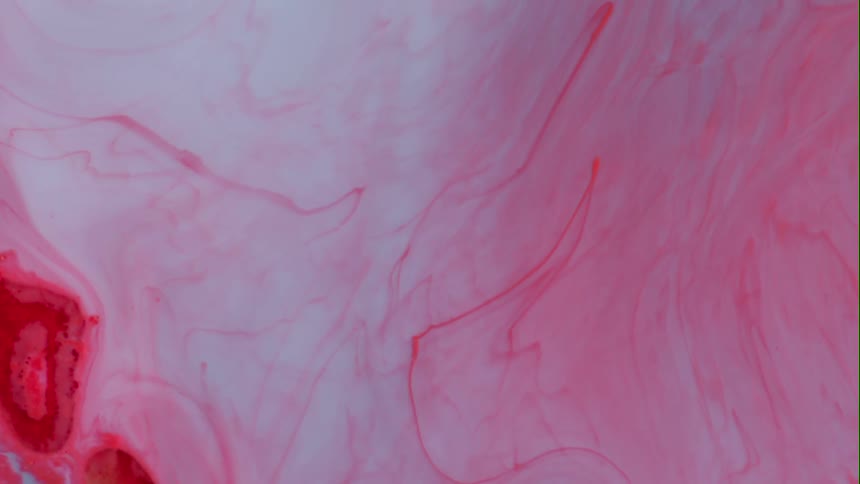 A wave of liquid causes red and white to swirl together