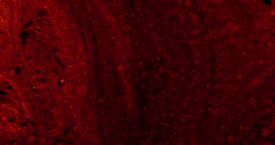 A deep red lava like substance is moving downward with orbs moving down with the movement