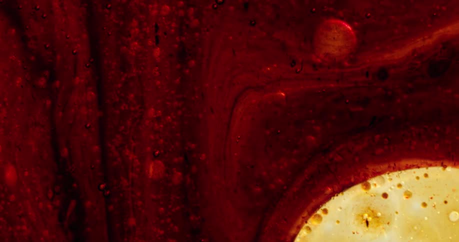 A sheer gold fluid combines with a dense red fluid