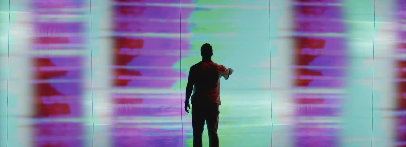 A man touches the display on the wall