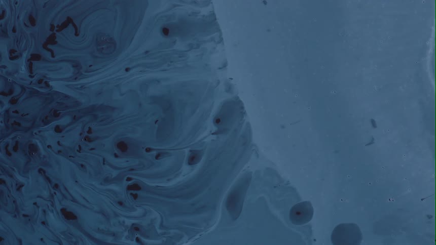 Darker textures of blending colors are on one side of a cold blue environment as it slowly moves