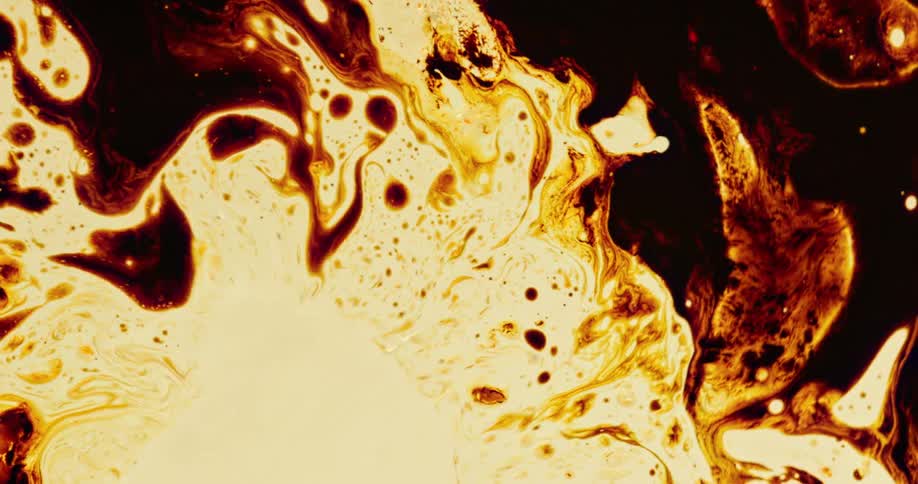 A burst of liquid pushes back darker colors on the surface then contracts