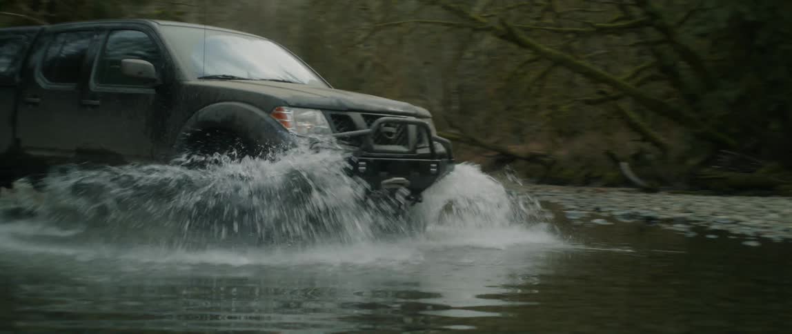 The truck drives through the water