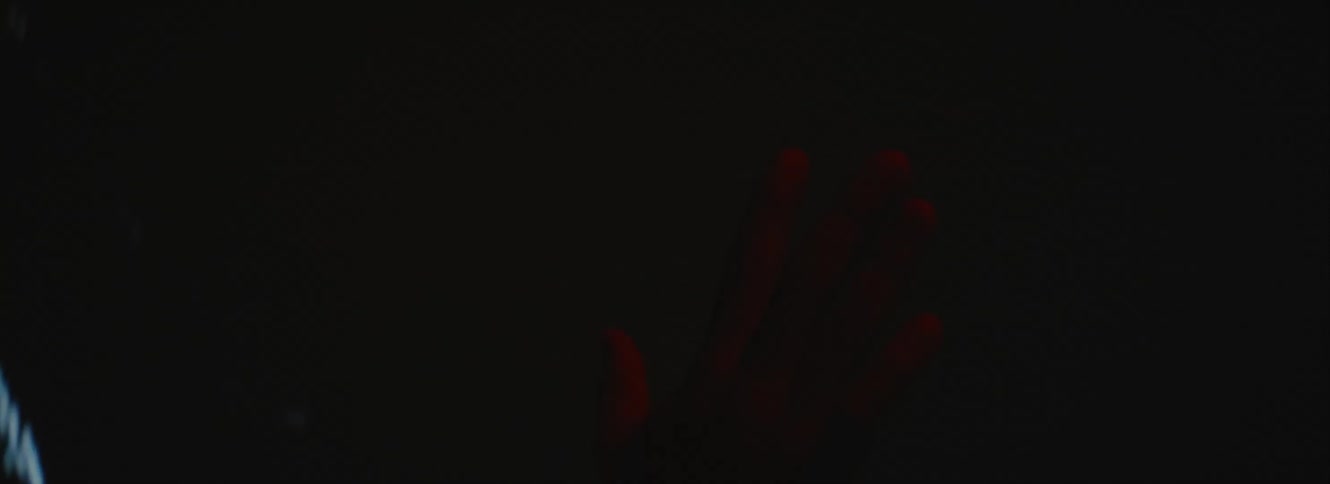 A man touches a screen playing video of static