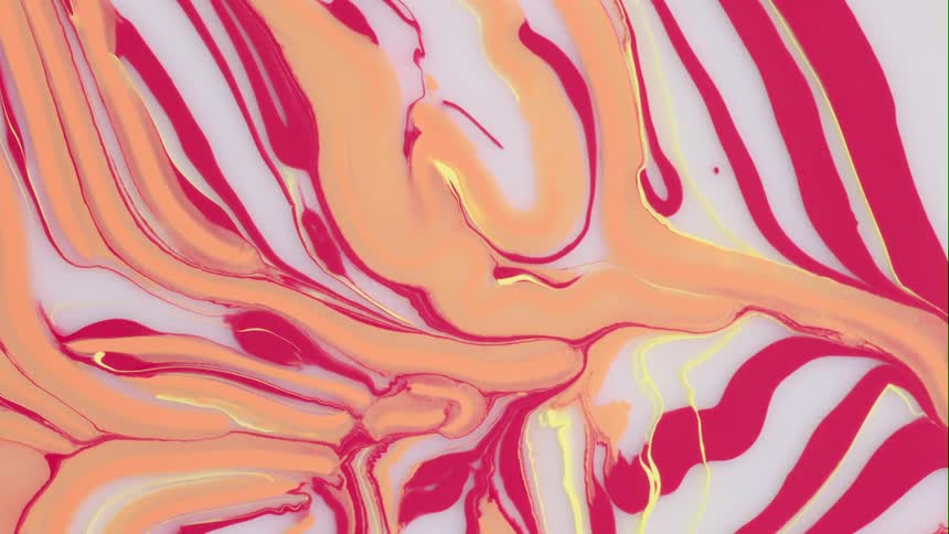 Colorful liquids that looks like paint are slowly mixing together