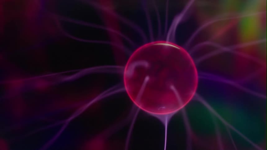 A glowing pink plasma sphere emitting electrical wisps is moving across the darkness