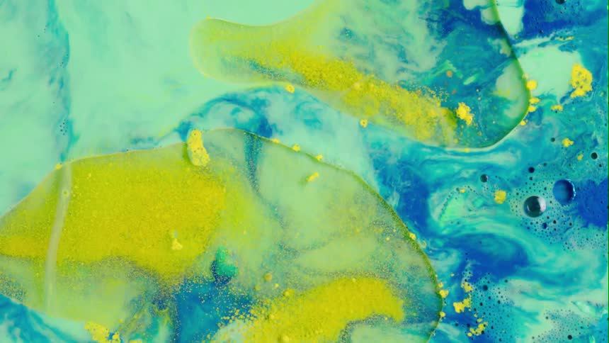 Organic colors blend as they move outward and dark orbs float on the surface