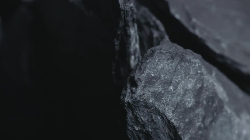 Light shines on the surface of slate rocks