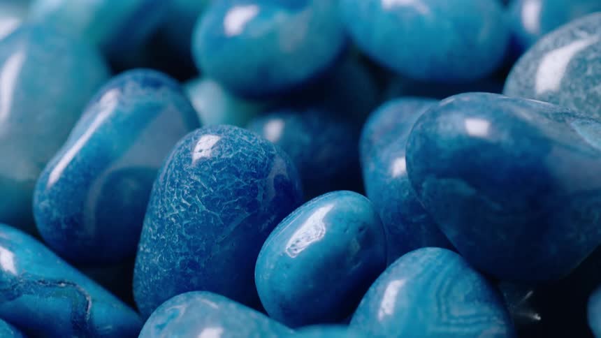 Pile of polished blue pebbles reflect light