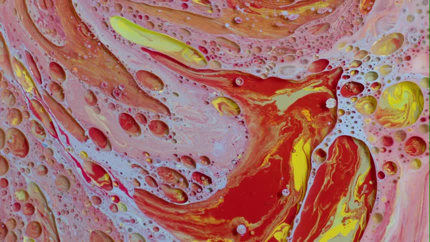 Swirling paint and dye with bubbles of color on the surface