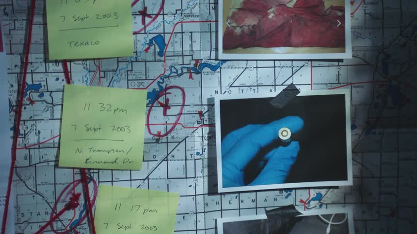 Photos from a crime scene and notes taped to a map