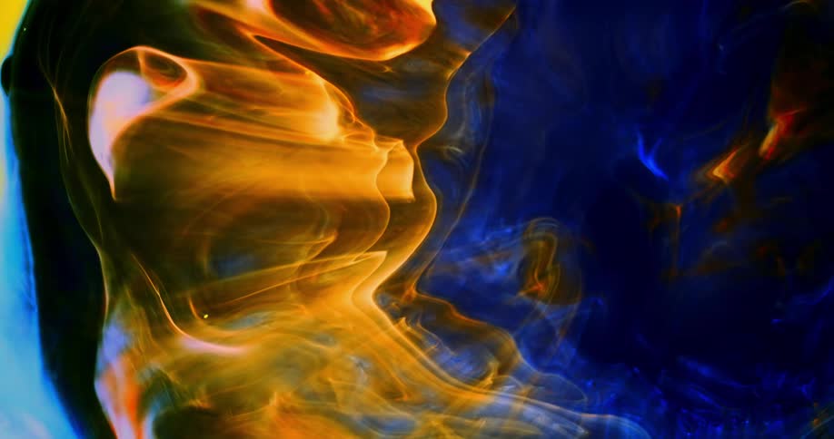 Wisps of glowing orange and blue shine as they move across the darkness