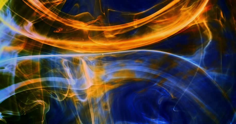 Blue and gold colors spread and combine in a mist