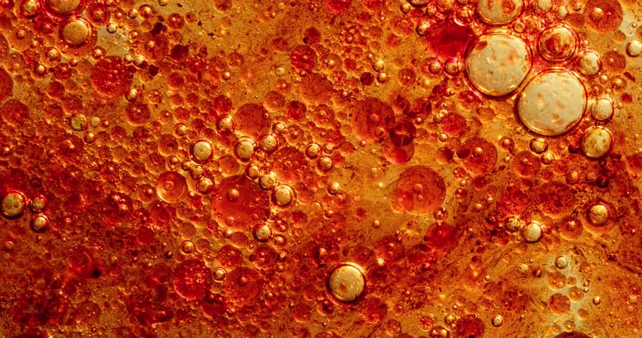 Bubbles burst up and pop and float on the liquid surface