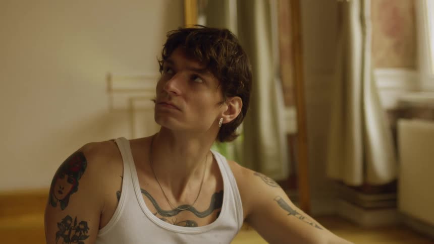 A man sits on the floor of his living room