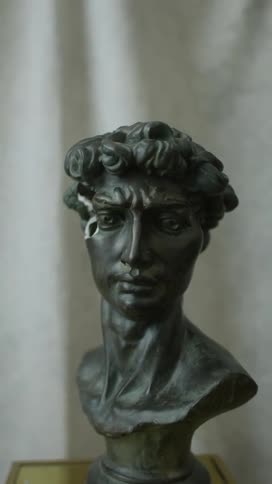A sculpture of a persons head on a table