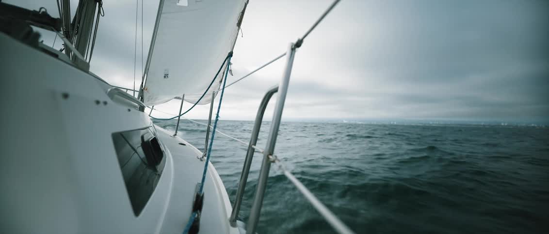 Yacht sails on ocean on stormy day