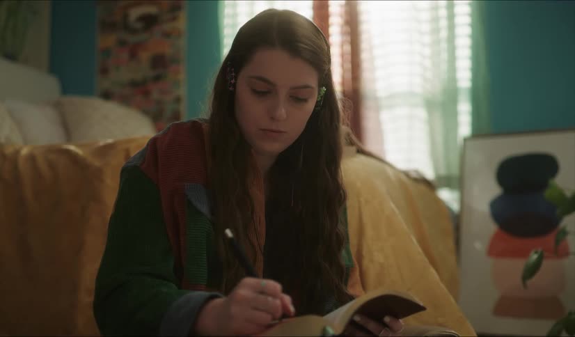A woman is writing in her notebook