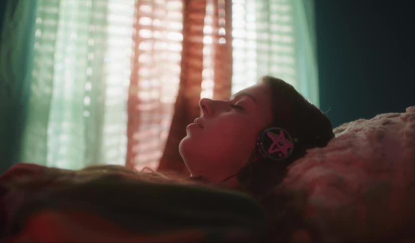 A woman is resting while listening to headphones
