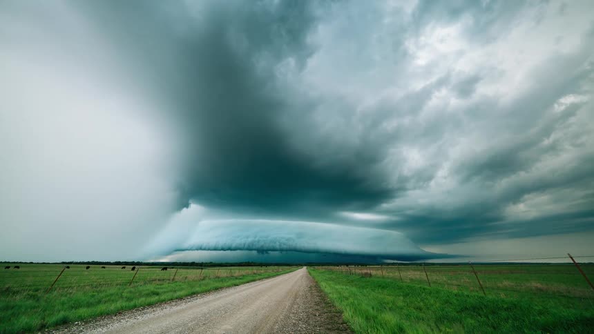 Storm clouds roll in over a rural road