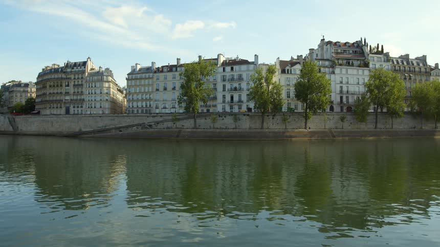 The ile saint luis island on the seine river in paris france buildings and sky reflected on water surface