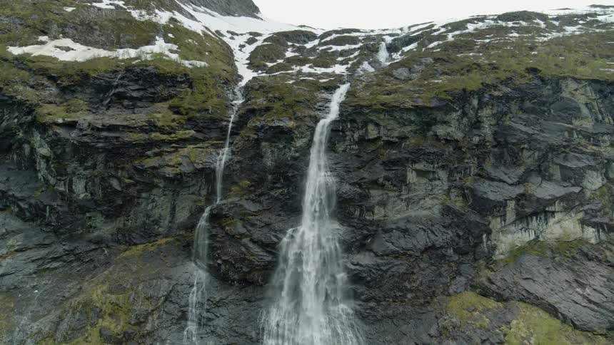 A waterfall crashing down the side of a mountain